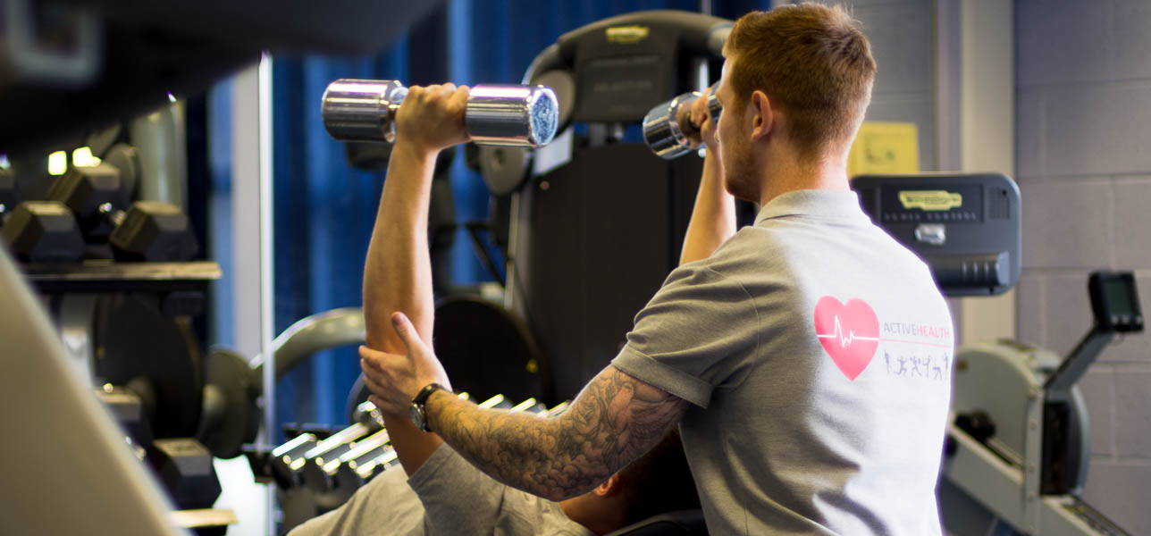 Client using weights in the gym